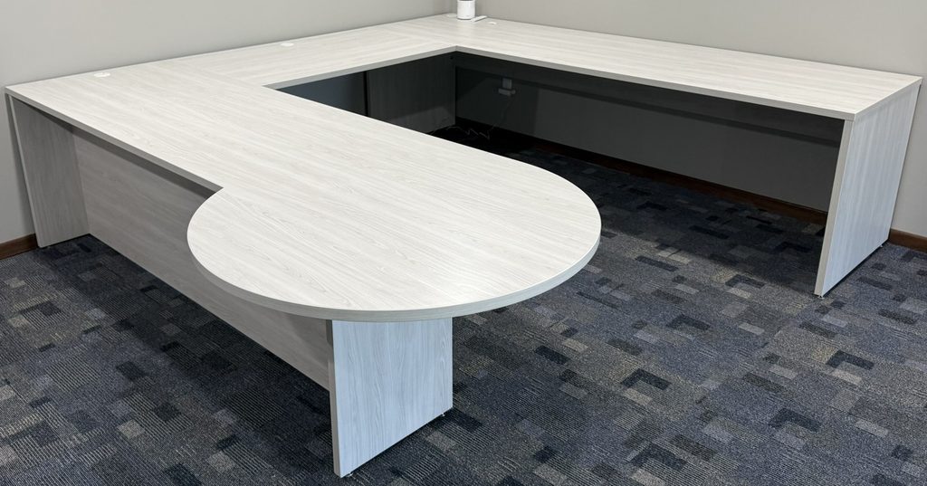 U-shaped desk with rounded bullet-end peninsula and panel ends in light gray wood-look finish